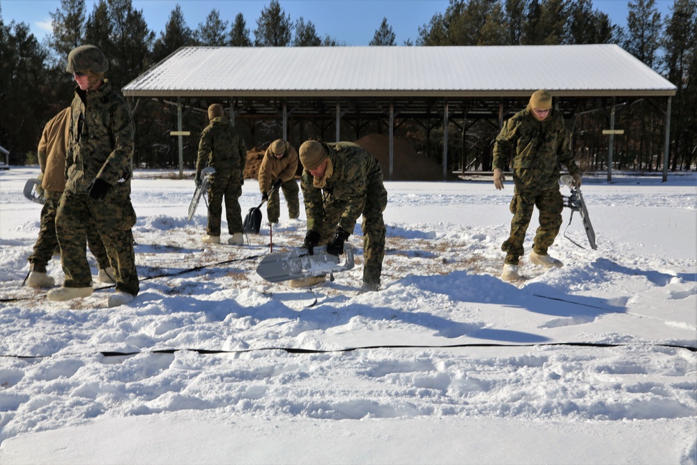 Cold-Weather Operations Course Class 18-04 students build Arctic tents during training at Fort McCoy