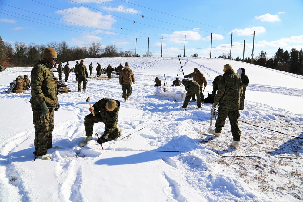 Cold-Weather Operations Course Class 18-04 students build Arctic tents during training at Fort McCoy