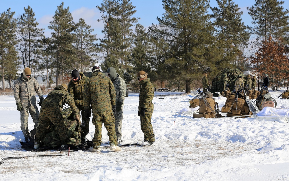 Cold-Weather Operations Course Class 18-04 students build Arctic tents during training at Fort McCoy