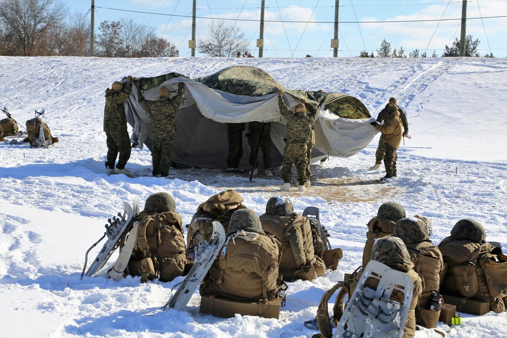 Cold-Weather Operations Course Class 18-04 students build Arctic tents during training at Fort McCoy