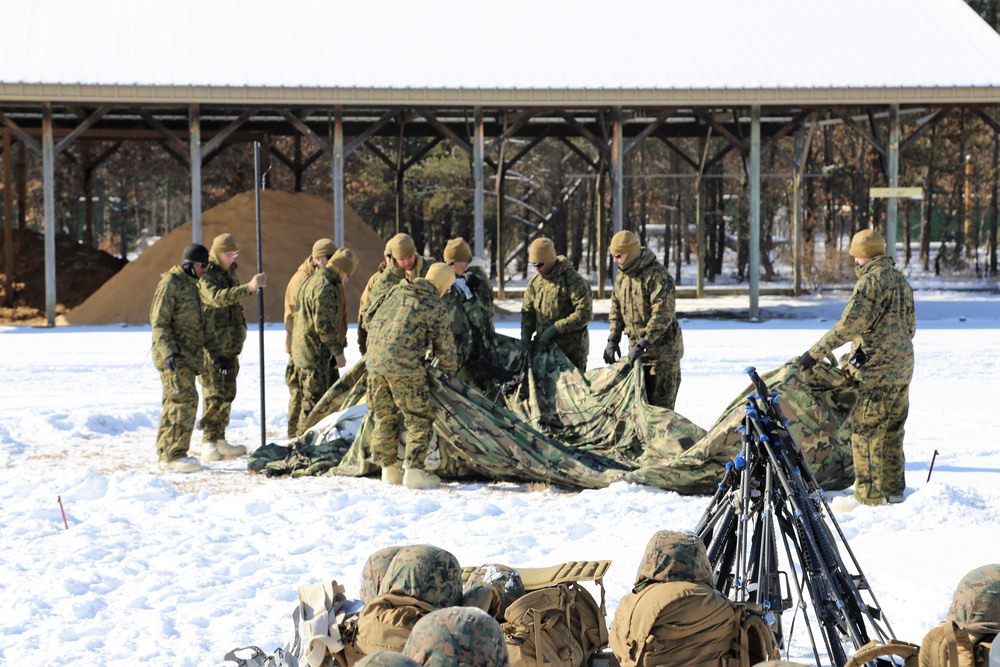 Cold-Weather Operations Course Class 18-04 students build Arctic tents during training at Fort McCoy