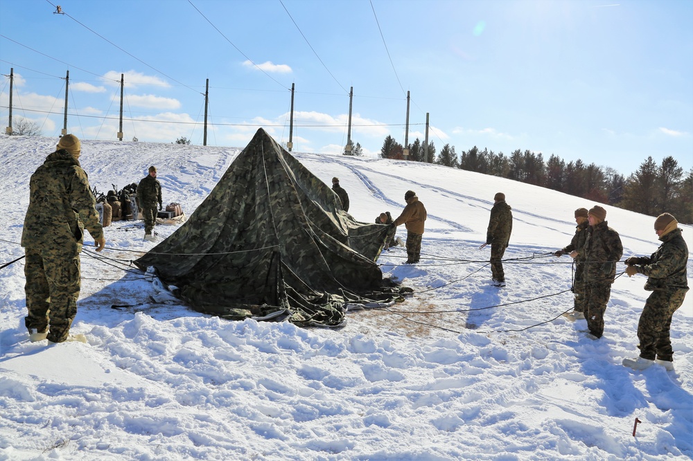 Cold-Weather Operations Course Class 18-04 students build Arctic tents during training at Fort McCoy