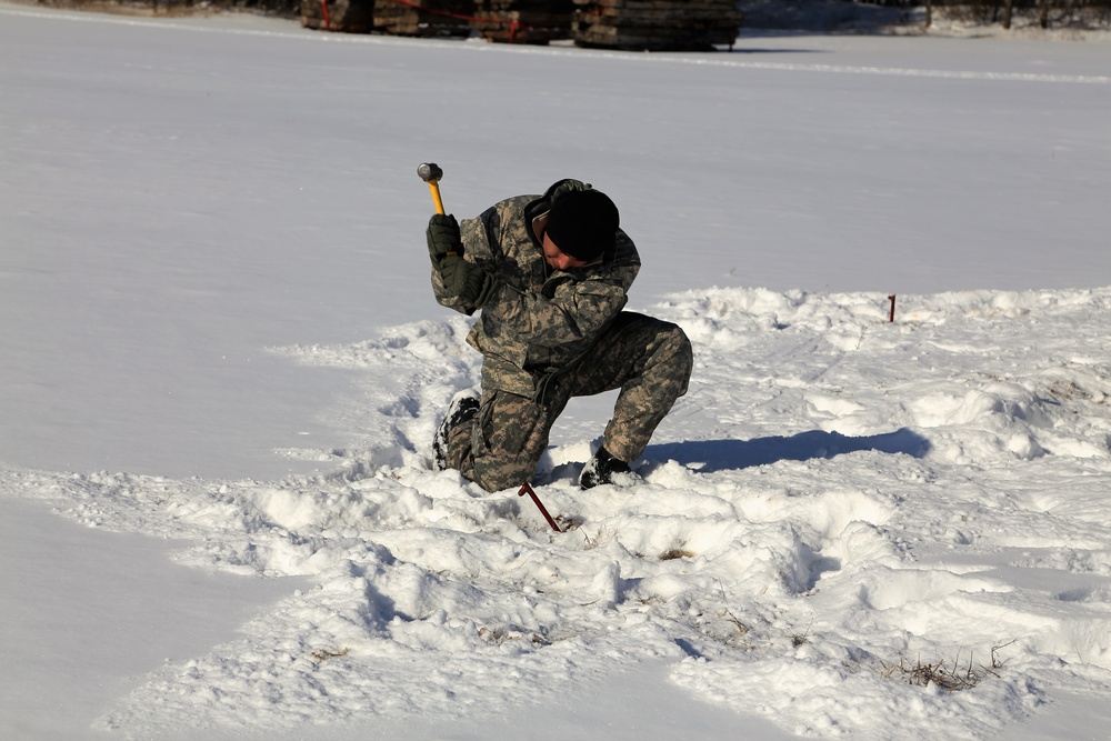 Cold-Weather Operations Course Class 18-04 students build Arctic tents during training at Fort McCoy