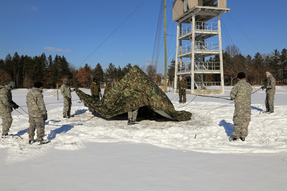 Cold-Weather Operations Course Class 18-04 students build Arctic tents during training at Fort McCoy