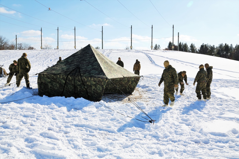 Cold-Weather Operations Course Class 18-04 students build Arctic tents during training at Fort McCoy