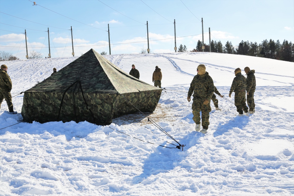 Cold-Weather Operations Course Class 18-04 students build Arctic tents during training at Fort McCoy