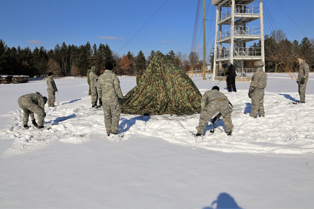 Cold-Weather Operations Course Class 18-04 students build Arctic tents during training at Fort McCoy