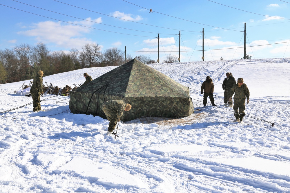 Cold-Weather Operations Course Class 18-04 students build Arctic tents during training at Fort McCoy