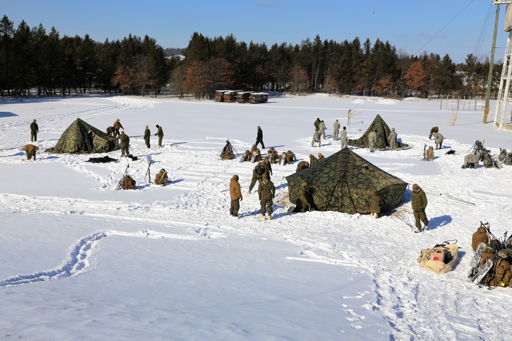 Cold-Weather Operations Course Class 18-04 students build Arctic tents during training at Fort McCoy