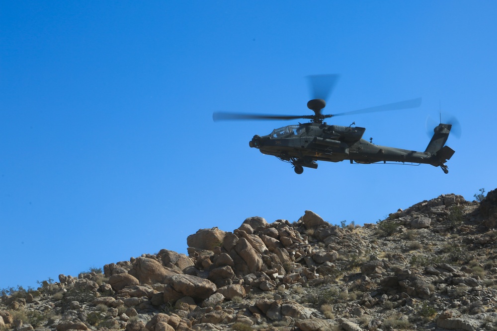 U.S. Soldiers  scout the training area for simulated enemies in an AH-64 Apache