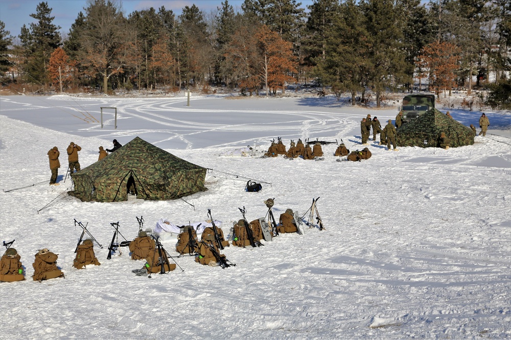 Cold-Weather Operations Course Class 18-04 students build Arctic tents during training at Fort McCoy