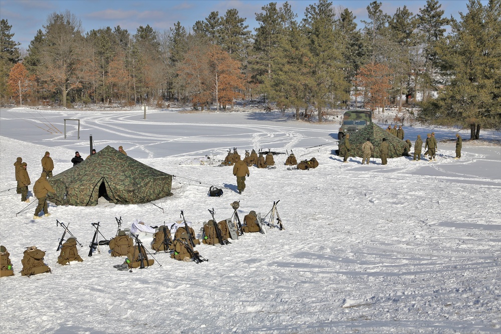 Cold-Weather Operations Course Class 18-04 students build Arctic tents during training at Fort McCoy