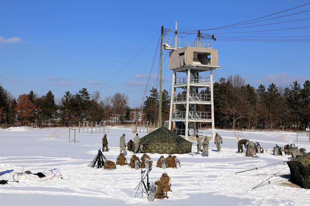 Cold-Weather Operations Course Class 18-04 students build Arctic tents during training at Fort McCoy