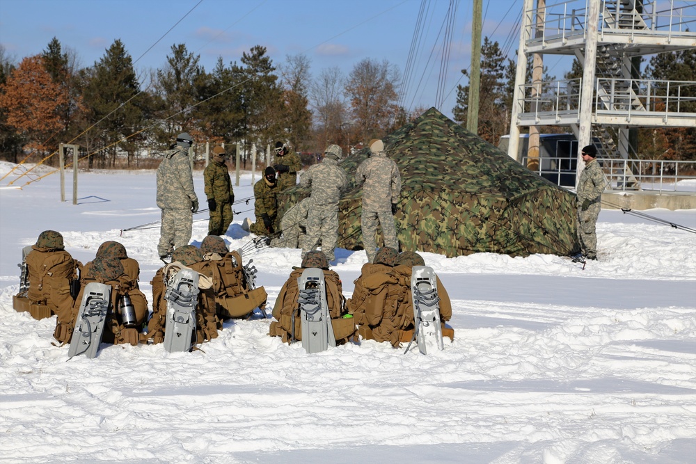 Cold-Weather Operations Course Class 18-04 students build Arctic tents during training at Fort McCoy