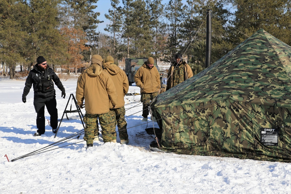 Cold-Weather Operations Course Class 18-04 students build Arctic tents during training at Fort McCoy