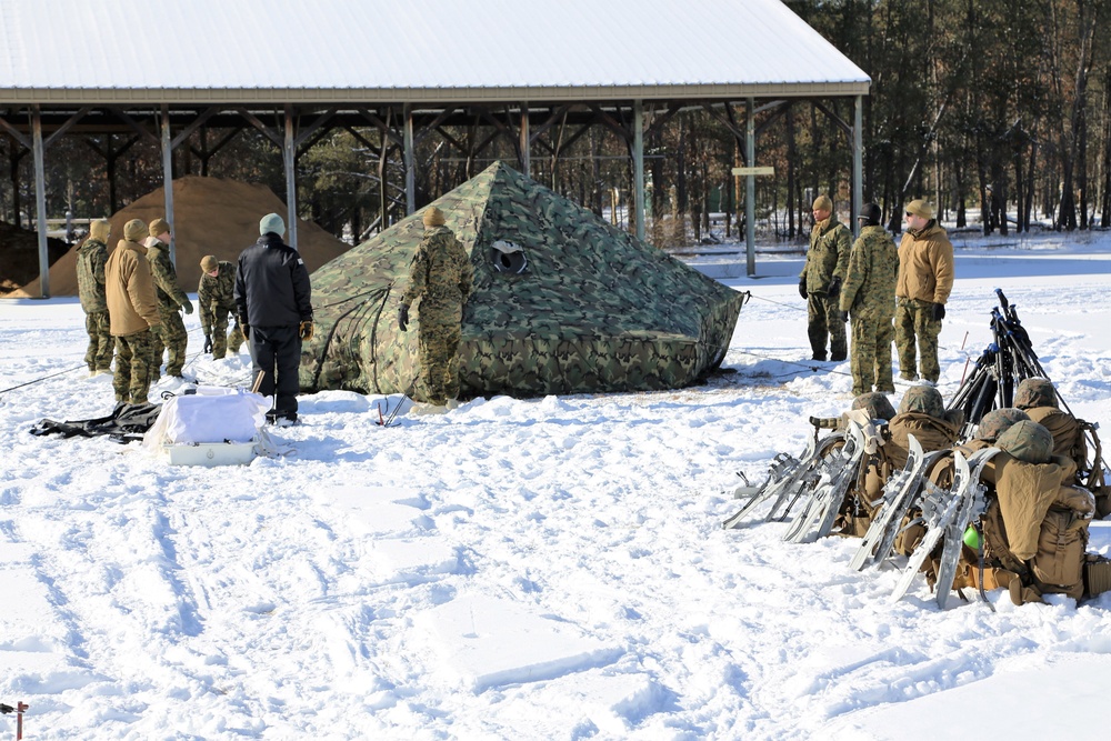 Cold-Weather Operations Course Class 18-04 students build Arctic tents during training at Fort McCoy