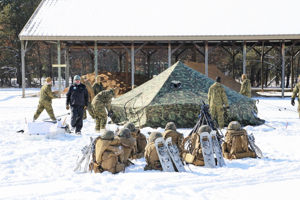 Cold-Weather Operations Course Class 18-04 students build Arctic tents during training at Fort McCoy