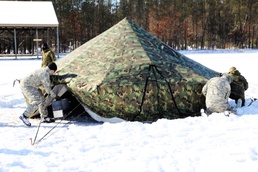 Cold-Weather Operations Course Class 18-04 students build Arctic tents during training at Fort McCoy