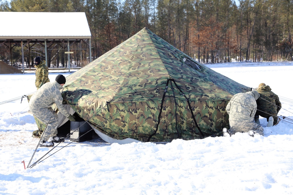 Cold-Weather Operations Course Class 18-04 students build Arctic tents during training at Fort McCoy