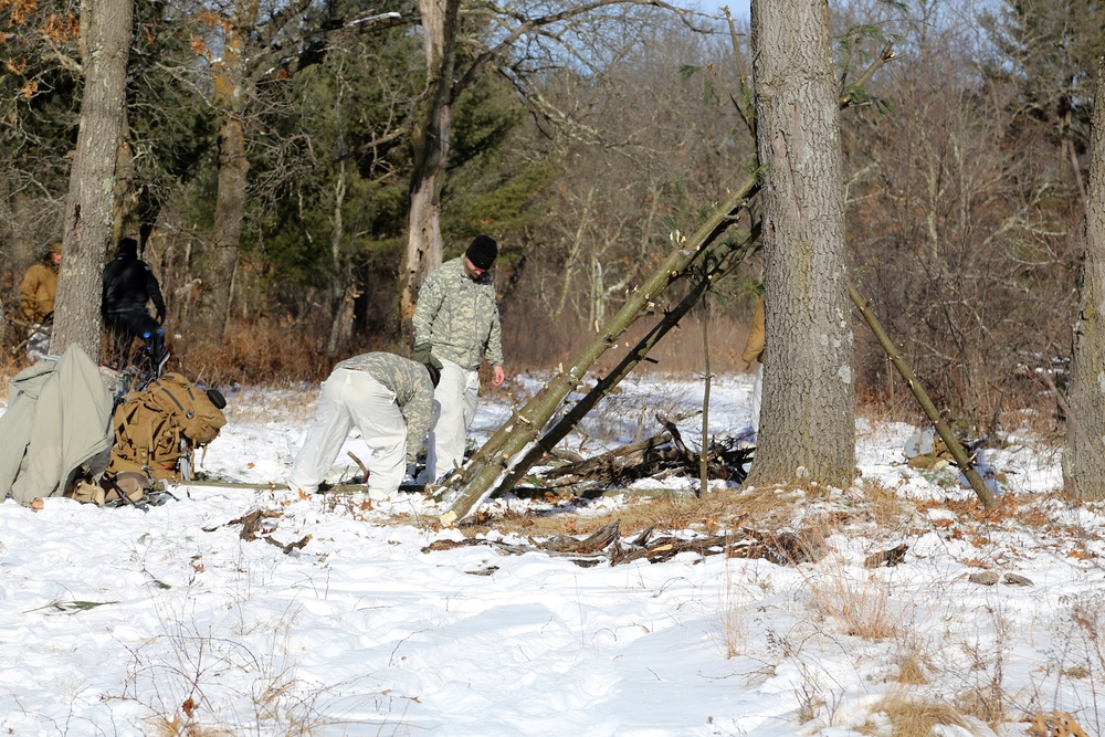 Cold-Weather Operations Course Class 18-04 students build improvised shelters during training at Fort McCoy