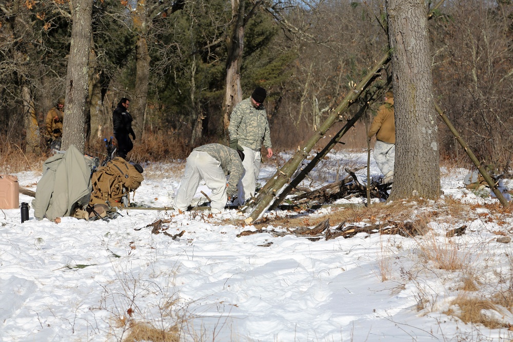 Cold-Weather Operations Course Class 18-04 students build improvised shelters during training at Fort McCoy