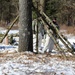 Cold-Weather Operations Course Class 18-04 students build improvised shelters during training at Fort McCoy