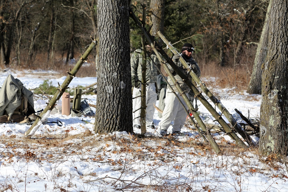 Cold-Weather Operations Course Class 18-04 students build improvised shelters during training at Fort McCoy