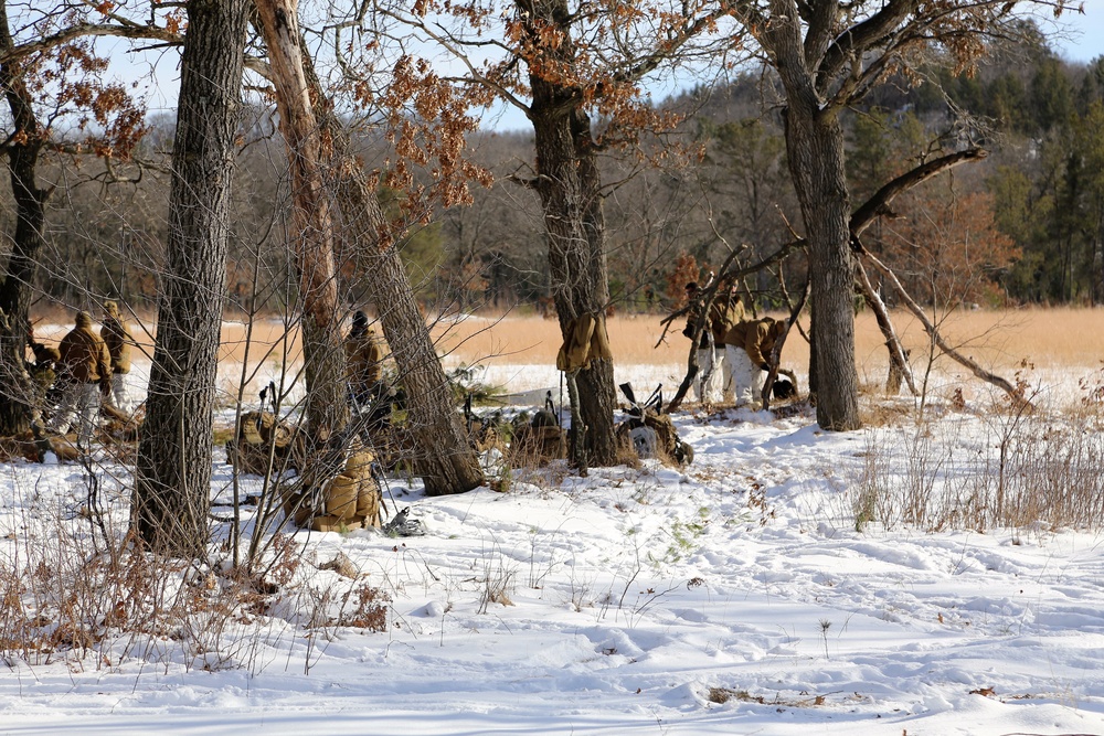 Cold-Weather Operations Course Class 18-04 students build improvised shelters during training at Fort McCoy