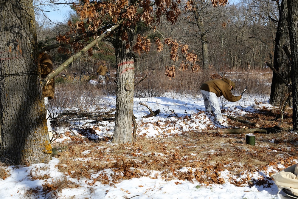 Cold-Weather Operations Course Class 18-04 students build improvised shelters during training at Fort McCoy