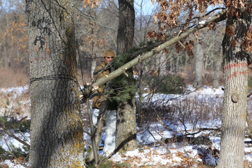 Cold-Weather Operations Course Class 18-04 students build improvised shelters during training at Fort McCoy