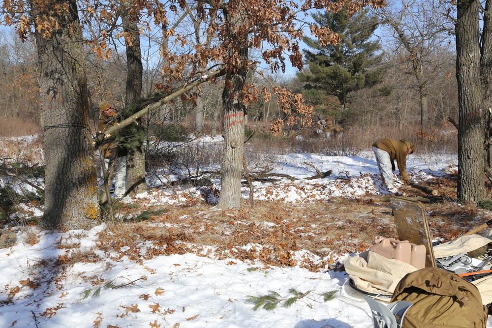 Cold-Weather Operations Course Class 18-04 students build improvised shelters during training at Fort McCoy