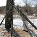 Cold-Weather Operations Course Class 18-04 students build improvised shelters during training at Fort McCoy