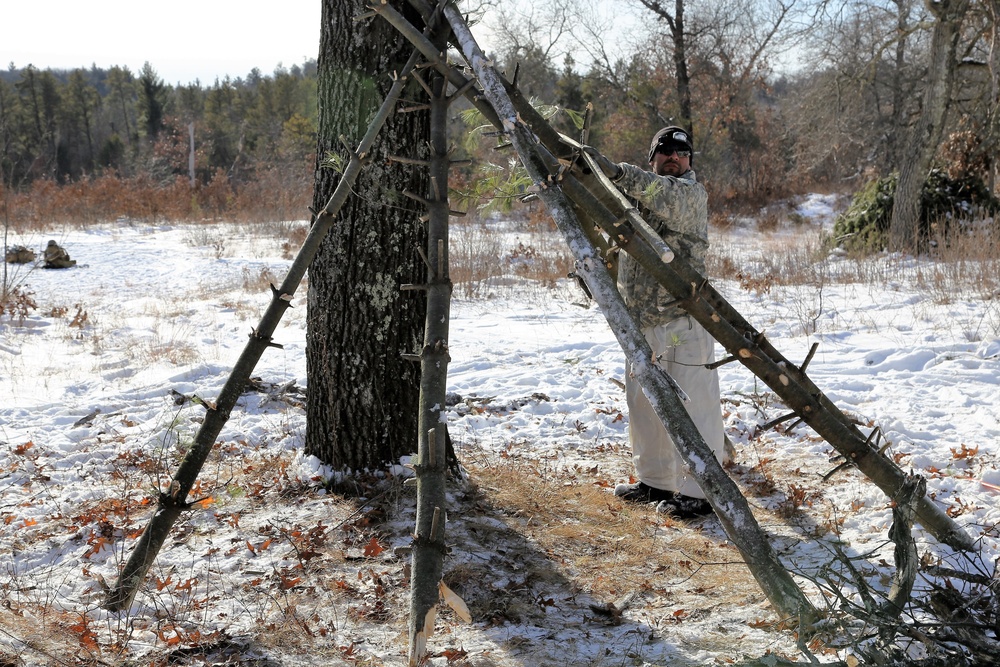 Cold-Weather Operations Course Class 18-04 students build improvised shelters during training at Fort McCoy