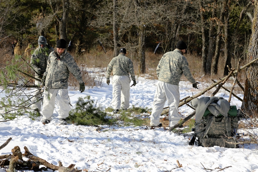 Cold-Weather Operations Course Class 18-04 students build improvised shelters during training at Fort McCoy