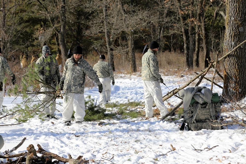 Cold-Weather Operations Course Class 18-04 students build improvised shelters during training at Fort McCoy