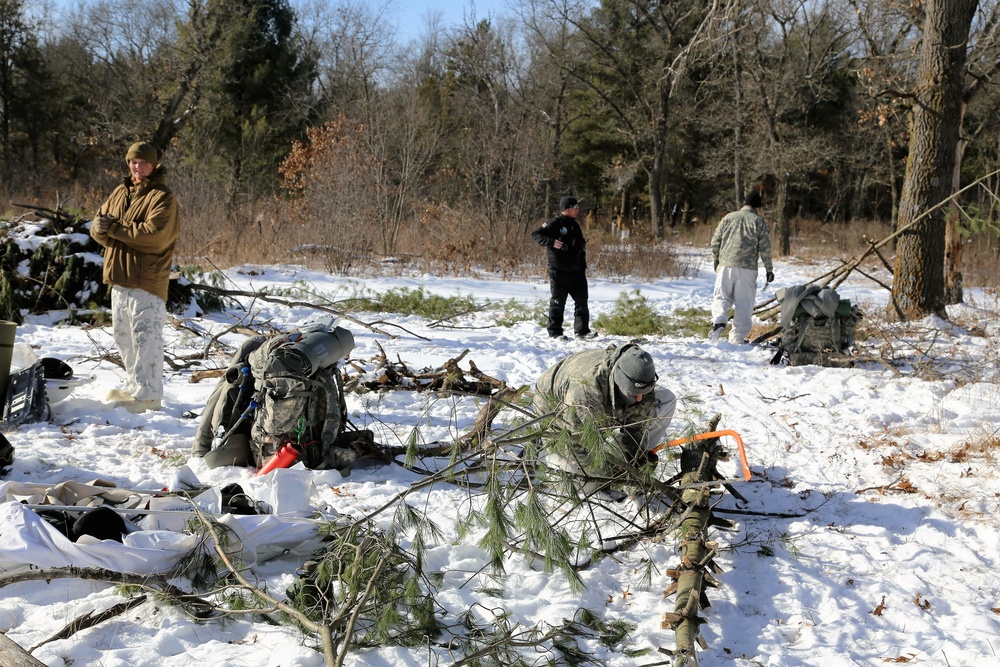 Cold-Weather Operations Course Class 18-04 students build improvised shelters during training at Fort McCoy