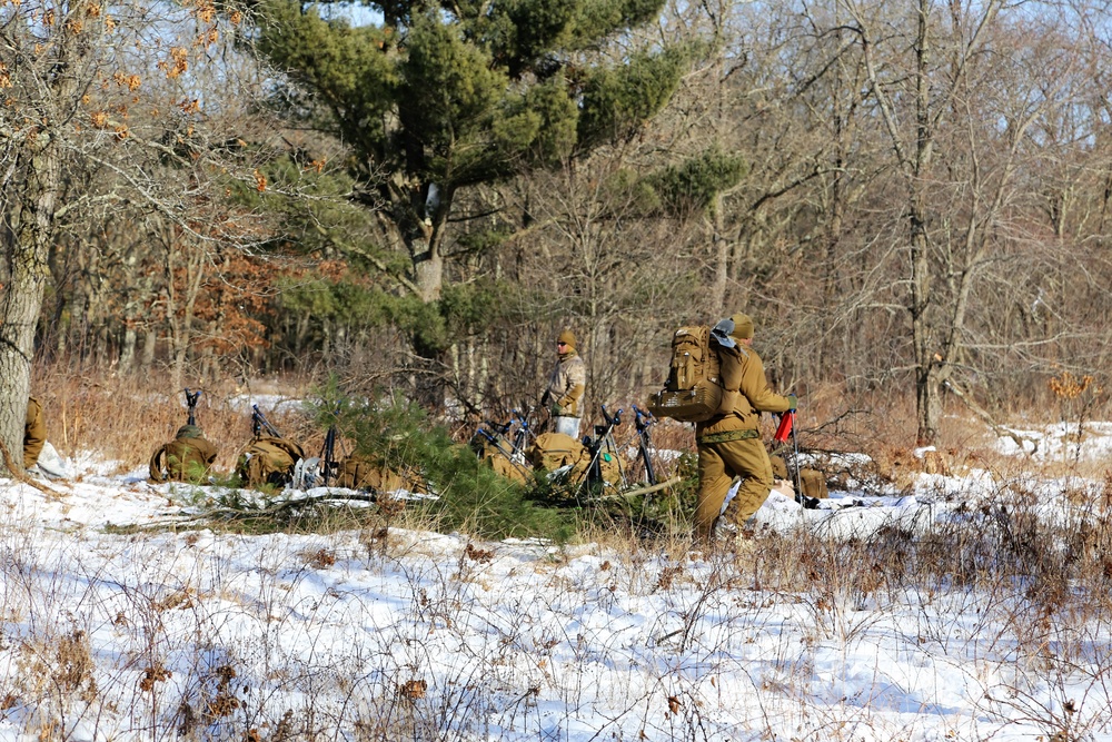 Cold-Weather Operations Course Class 18-04 students build improvised shelters during training at Fort McCoy