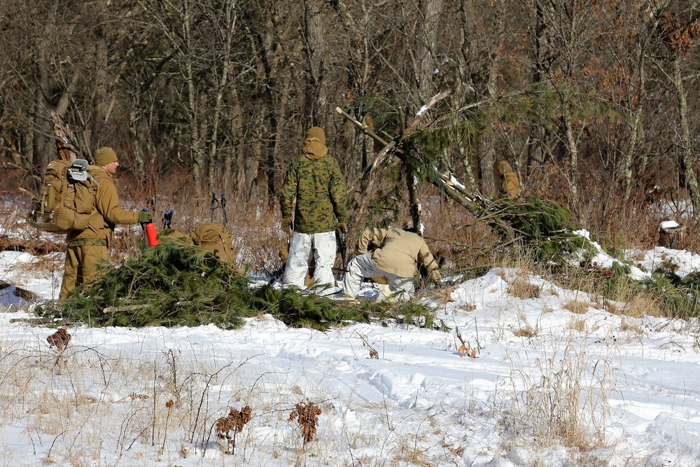 Cold-Weather Operations Course Class 18-04 students build improvised shelters during training at Fort McCoy