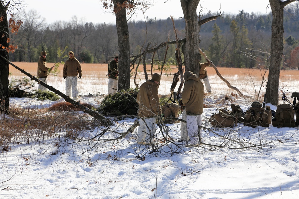 Cold-Weather Operations Course Class 18-04 students build improvised shelters during training at Fort McCoy