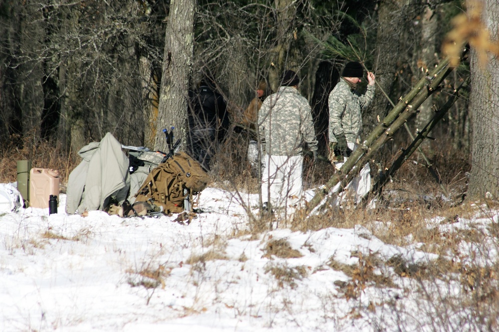 Cold-Weather Operations Course Class 18-04 students build improvised shelters during training at Fort McCoy