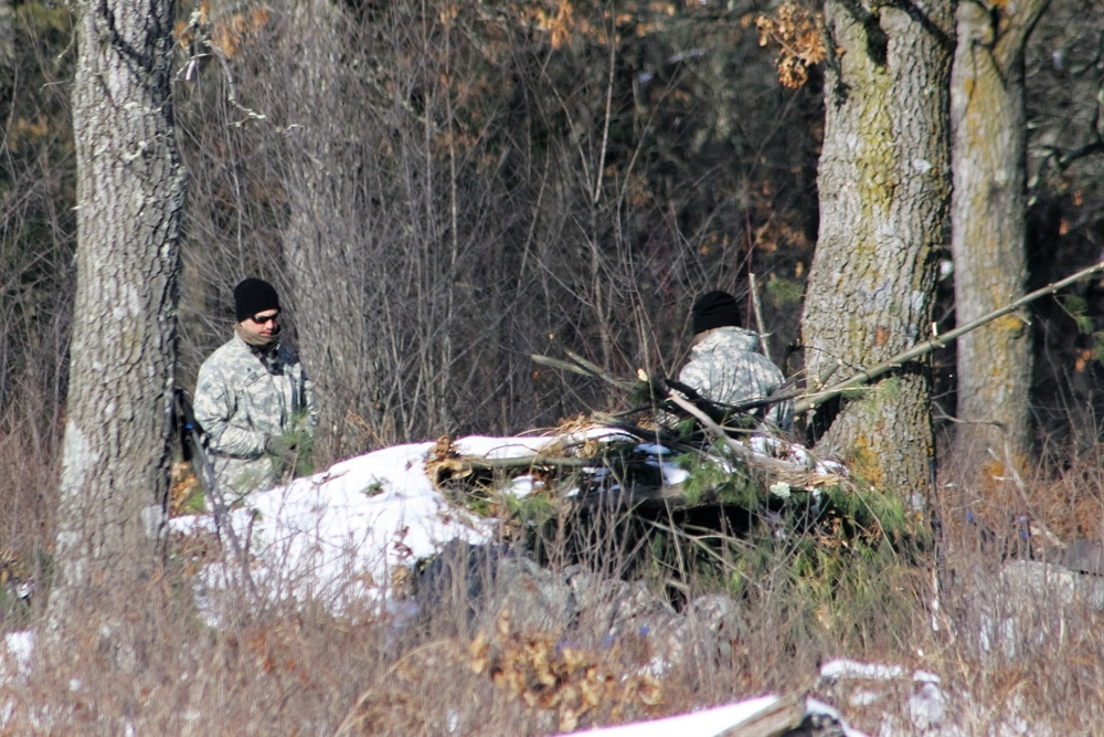 Cold-Weather Operations Course Class 18-04 students build improvised shelters during training at Fort McCoy