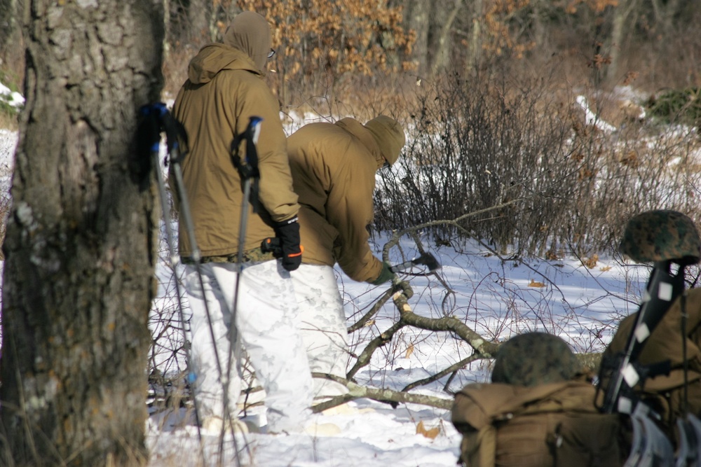 Cold-Weather Operations Course Class 18-04 students build improvised shelters during training at Fort McCoy