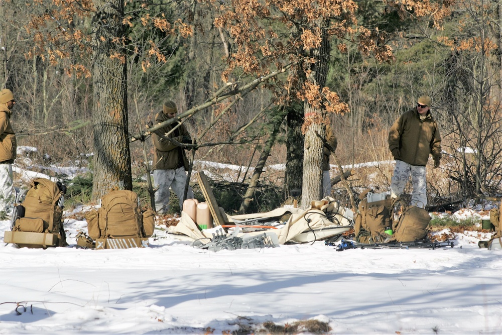 Cold-Weather Operations Course Class 18-04 students build improvised shelters during training at Fort McCoy