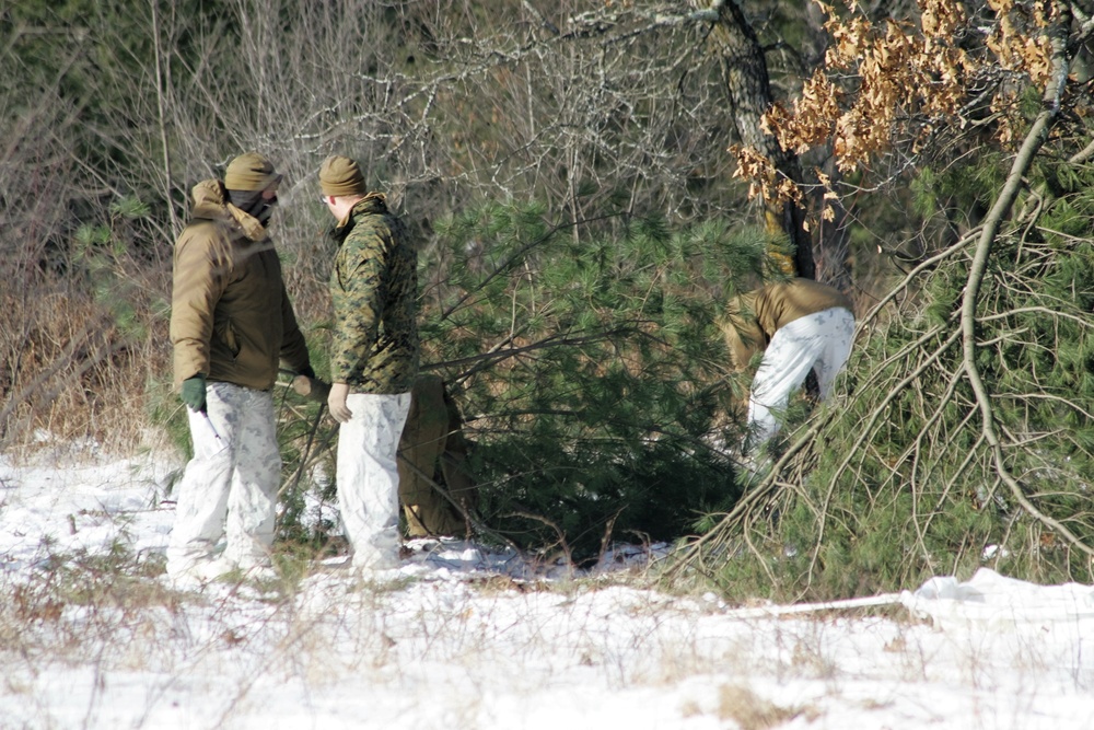 Cold-Weather Operations Course Class 18-04 students build improvised shelters during training at Fort McCoy