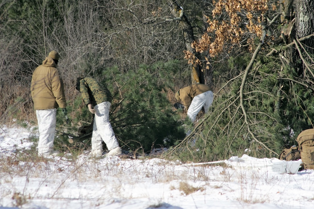 Cold-Weather Operations Course Class 18-04 students build improvised shelters during training at Fort McCoy