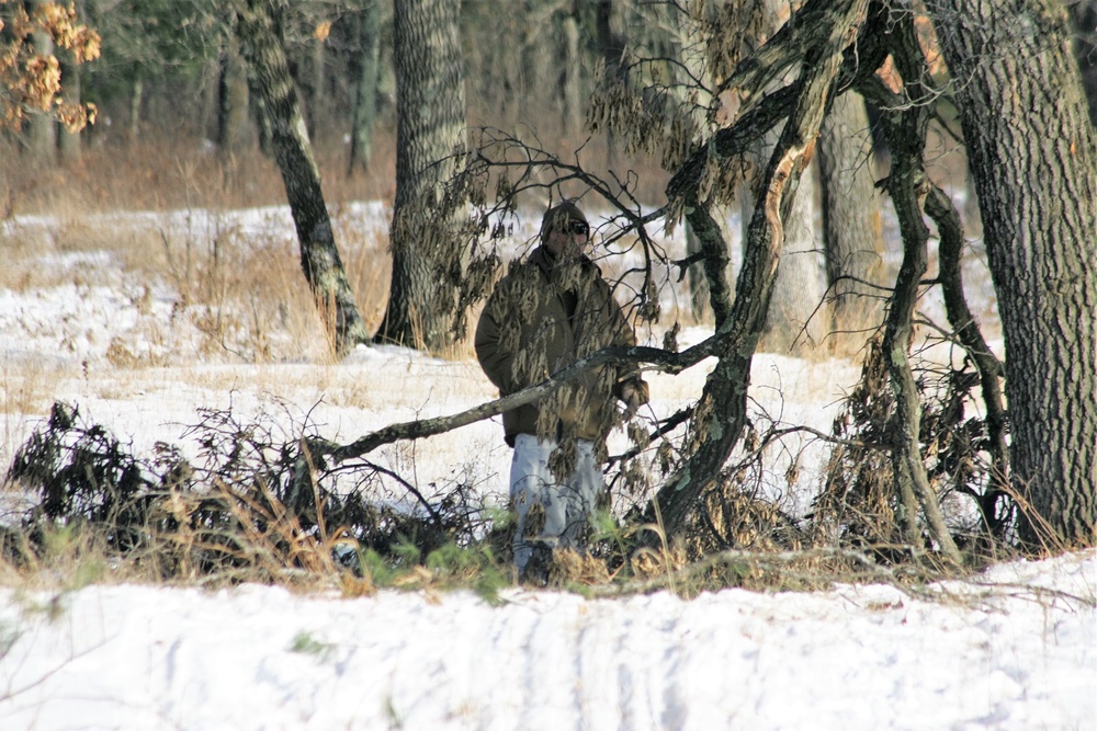 Cold-Weather Operations Course Class 18-04 students build improvised shelters during training at Fort McCoy