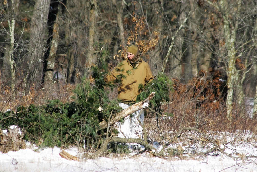 Cold-Weather Operations Course Class 18-04 students build improvised shelters during training at Fort McCoy