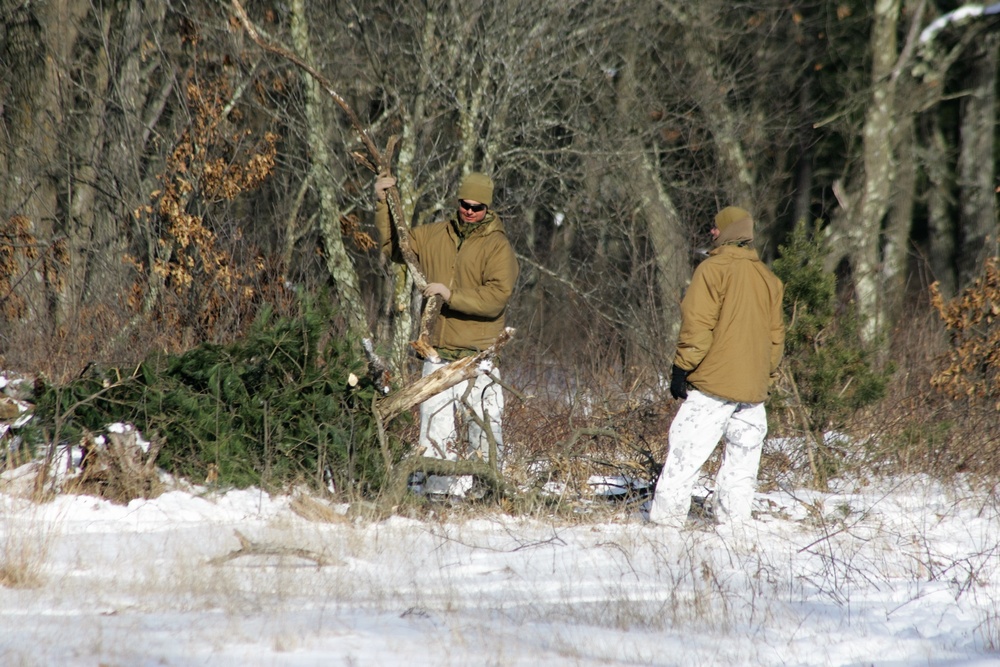 Cold-Weather Operations Course Class 18-04 students build improvised shelters during training at Fort McCoy