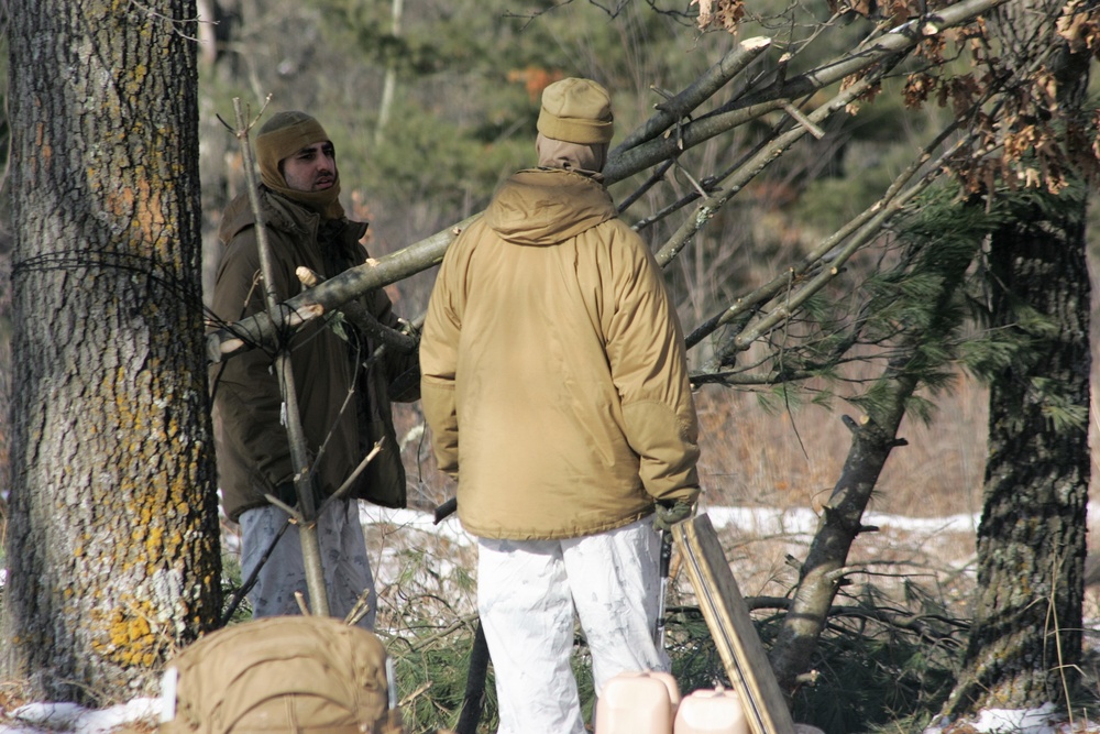 Cold-Weather Operations Course Class 18-04 students build improvised shelters during training at Fort McCoy