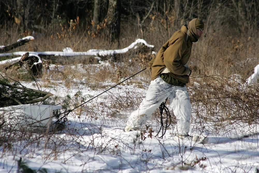 Cold-Weather Operations Course Class 18-04 students build improvised shelters during training at Fort McCoy